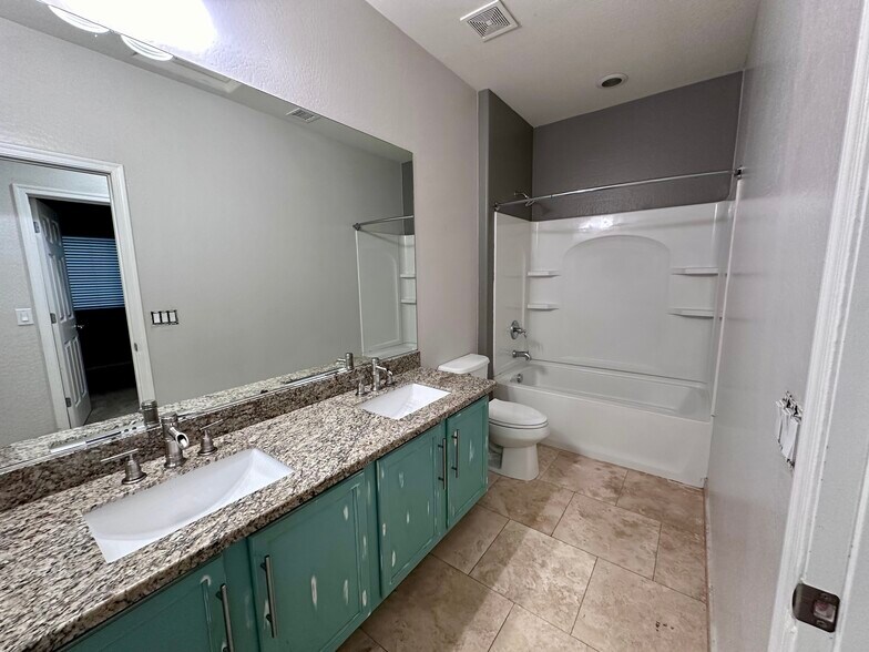 Bathroom 2 with granite counters and dual sinks - 18215 W Townley Ave