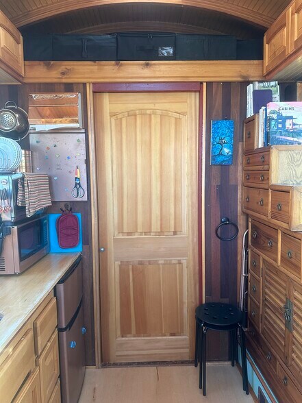 The pocket door separates the bathroom/entryway from the rest of the house with storage loft above. - 833 Valencia St