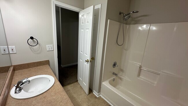 Upstairs bathroom has a shower/tub and linen closet. - 1211 Goldridge Dr SW