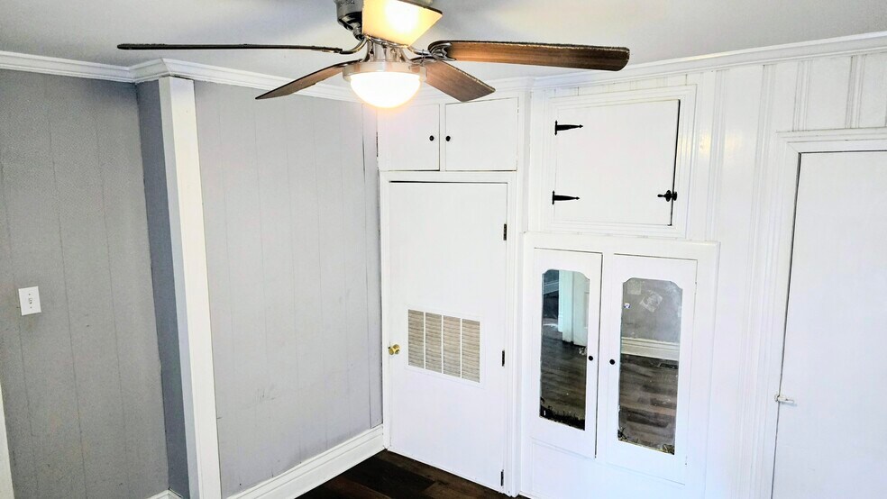 Bedroom number two has a vintage armoire closet wall storage unit and vintage original door - 3348 Bohannon Ave