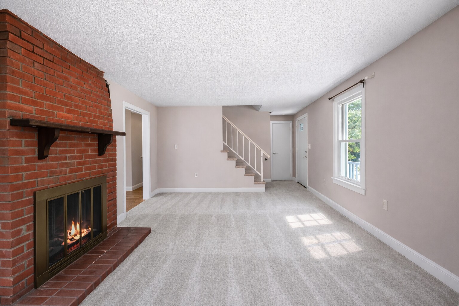 Comfortable living room with fireplace and natural light - 16 Miller Rd