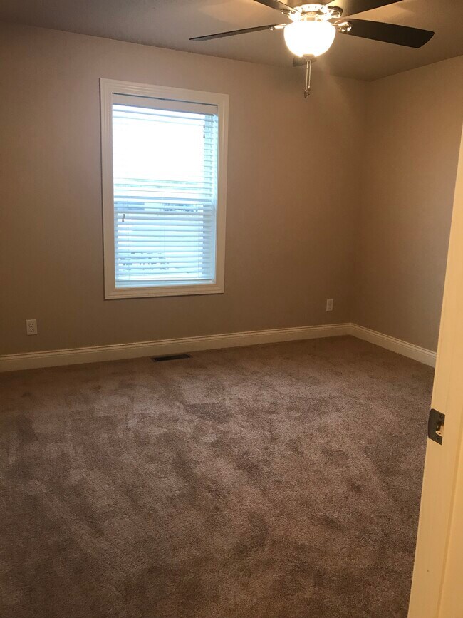 2nd bedroom, carpeted with ceiling fan. - 113 Scenic Dr