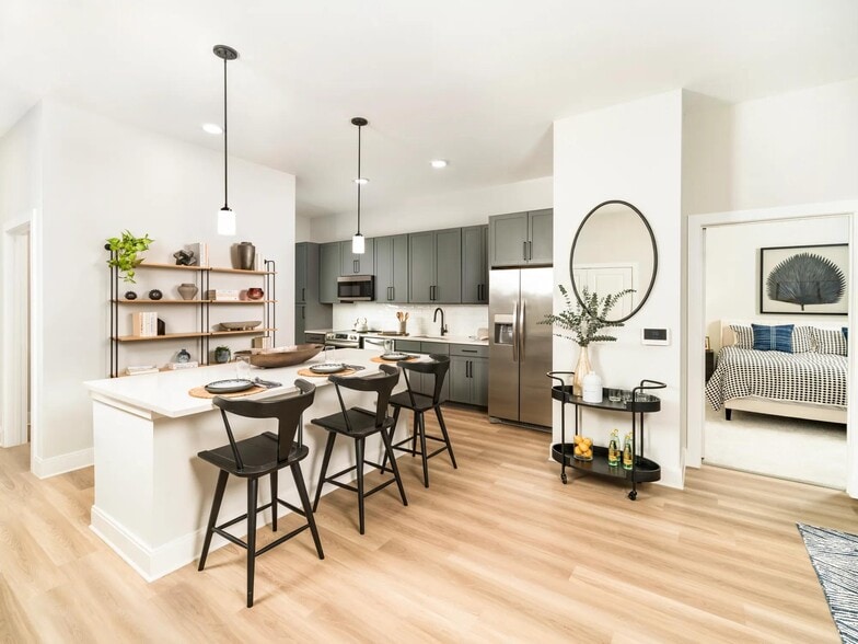 The kitchens at Modera Liberty Row shine with sleek cabinetry, stainless steel appliances, and spacious islands perfect for dining. - Modera Liberty Row