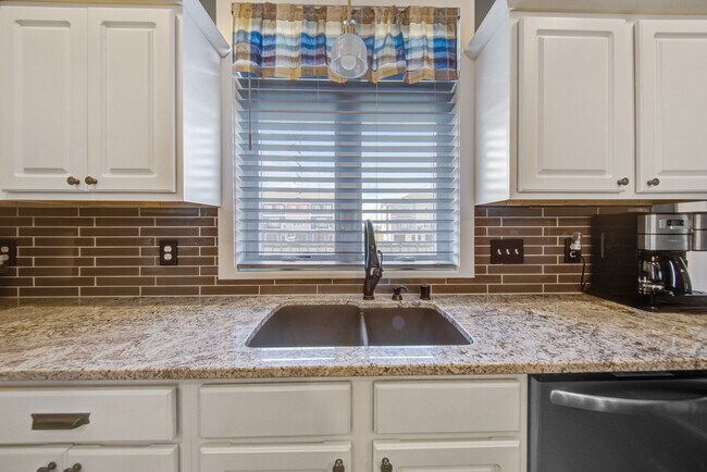 Delta faucet and glass tile backsplash - 2163 Rolling Green Ln