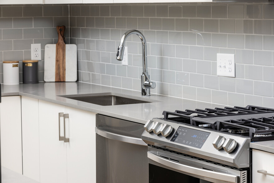 Grey tile backsplash and grey quartz countertops - Avalon North Andover