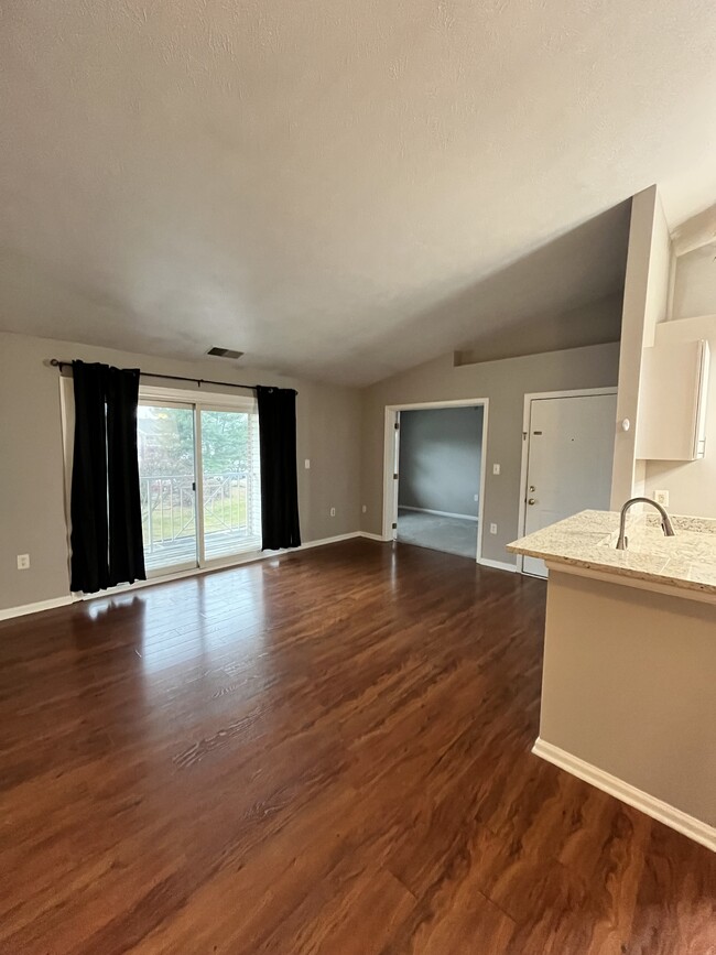 Living room with a sliding door balcony view - 1208 Mist Wood Ct