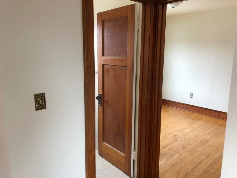 hallway from the kitchen to the bedrooms and bathroom. - 623 S 60th St