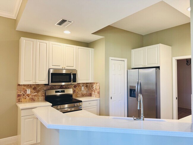 Building Photo - Experience Bell Tower Park. GATED ground floor 2 Bed 2 Bath Den 1 Car Garage Condo.