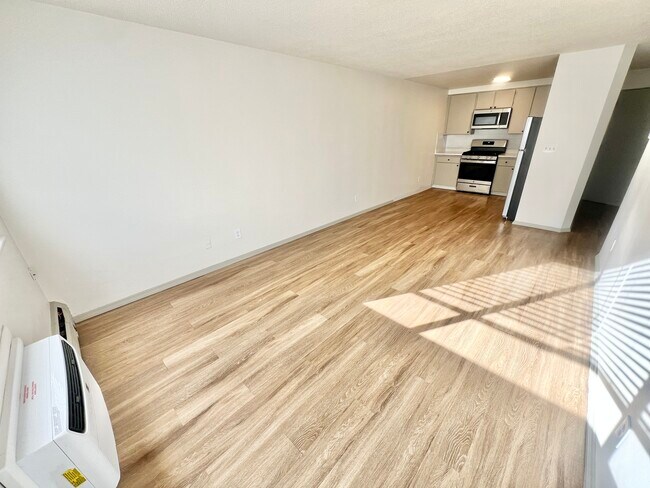 Experience the perfect blend of style and functionality in this open-concept apartment space. - Harmony Apartments