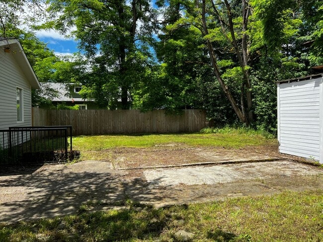 Building Photo - This 3-bedroom 1-bathroom house has a large front yard and a mostly fenced backyard.