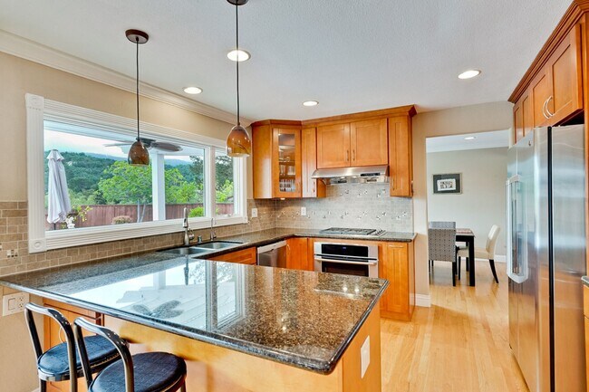Building Photo - Remodeled 5 Bedroom Home with Heated Pool, Hillside Views, Solar, and Sunrise and Sunset Views in...