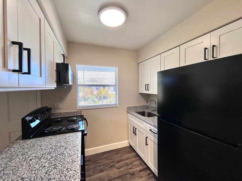 Experience the elegance of this contemporary kitchen, designed with style and functionality in mind. - Inertia Apartments