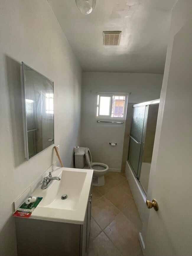 Bathroom with large new vanity and porcelain tile and bathtub - all new fixtures - 10513 Crenshaw Blvd