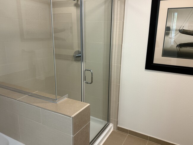 A spacious and elegant master bathroom featuring both a shower and a soaking tub. - 1655 N California Blvd