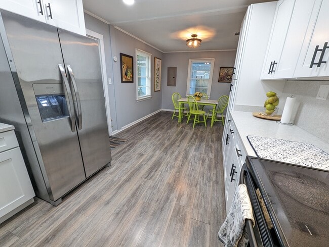 The kitchen has been recently renovated with modern amenities, stainless appliances, a dishwasher, l - 4107 Crane St