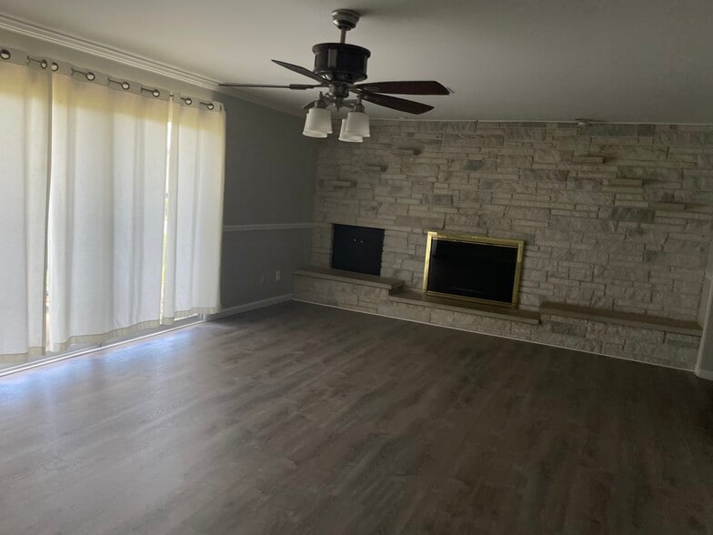 Living room with additional fireplace and access to beautiful backyard - 302 Coronation Dr