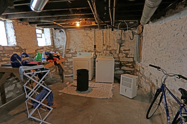 Unfinished basement with new laundry appliances and de-humidifier - 372 E Oakland Ave