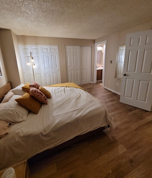 Primary bedroom with entrance to bathroom - 15707 4th Ave S