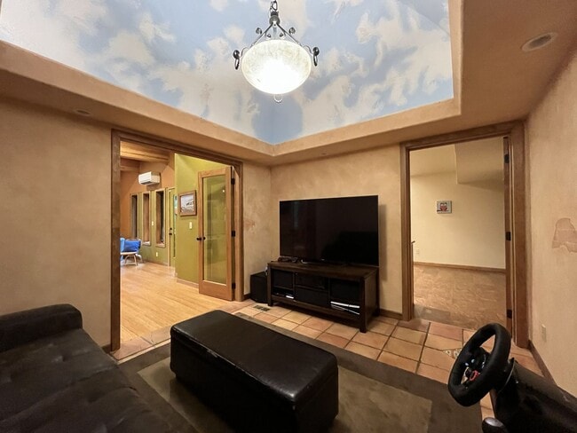 Building Photo - One-of-a-Kind Custom Home with Wall of Windows, Stone Fireplaces, Expansive Entertainment Space &...