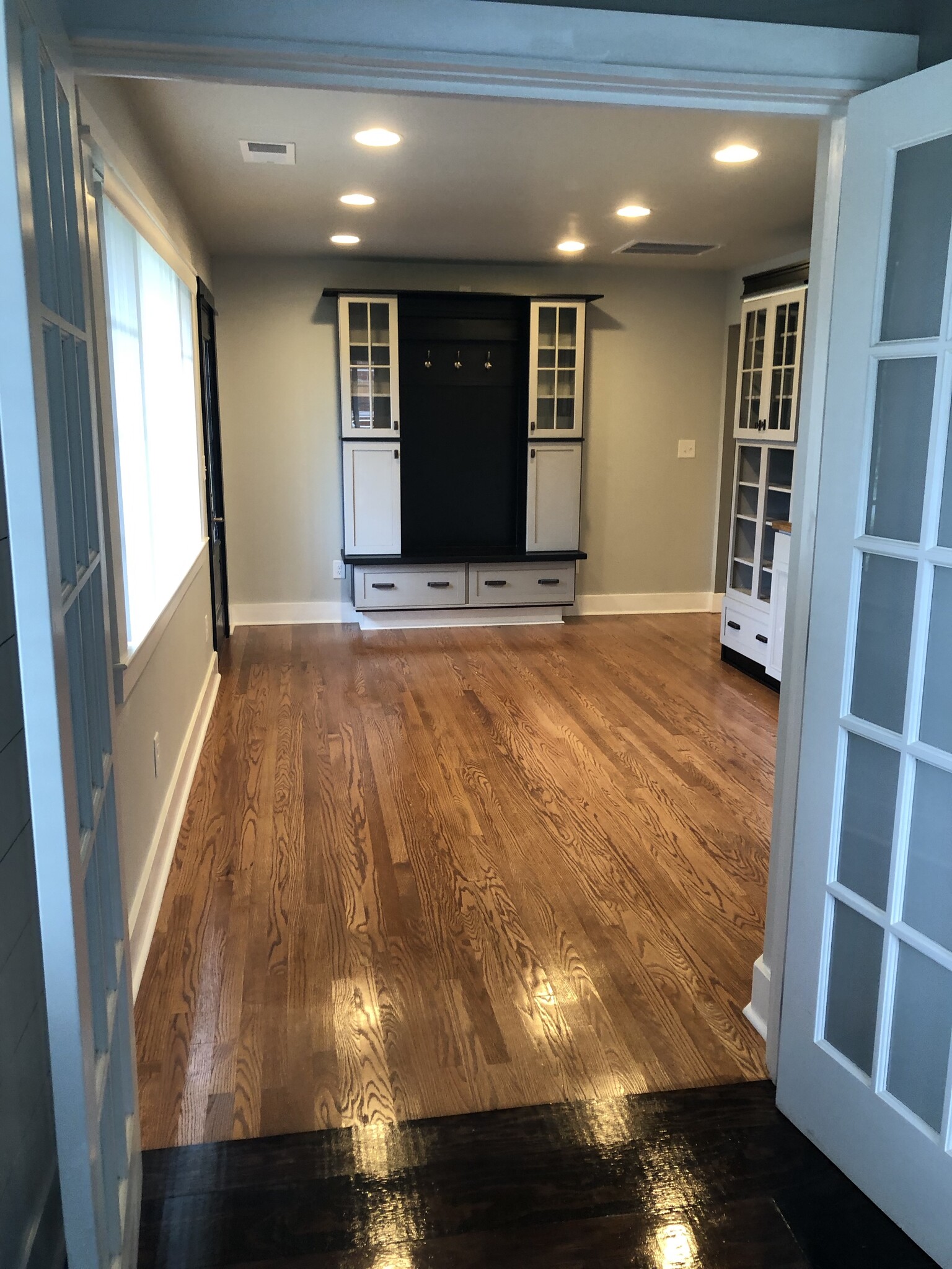 Living room with lots of built-in cabinetry for extra storage. - 20400 Church St