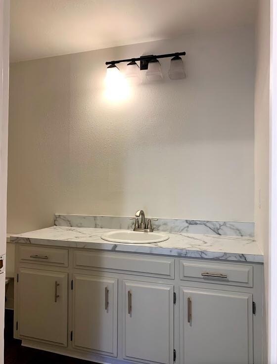 Bathroom features large mirror and fully-lit fixture. Photo from prior to completed installation. - 5339 Baxter Ct SE
