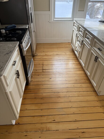 Marble countertops with stainless steel convection oven, hood vent fan, microwave, and refrigerator - 16 Tecumseh Street