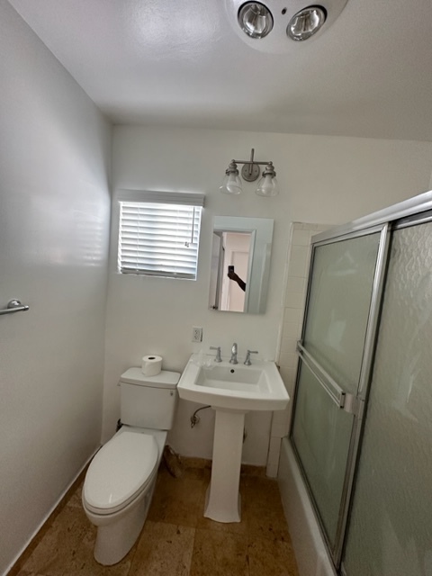 Wonderful bathroom with shower above the tub and sliding glass doors - 5545 1/2 Allott Ave