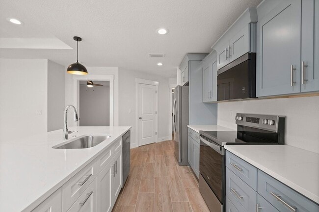 Building Photo - NEW Villa-duplex home with quartz counters, 2-car garage, and a rear patio