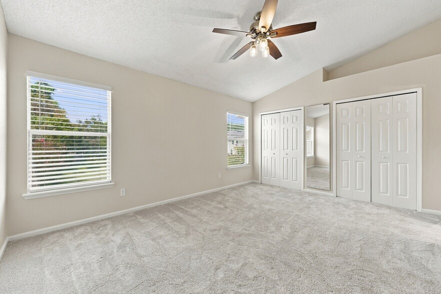 Spacious primary bedroom with brand-new carpet and abundant natural light. - 3622 Caroline Vale Blvd