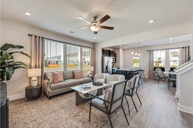 Living Room with Vinyl Plank Flooring and Lots of Windows for Natural Light - Covey Homes Addison