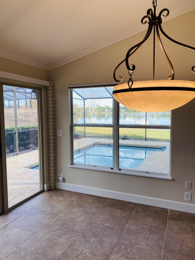 Dining area overlooking pool and lake - 556 Wekiva Cove Rd