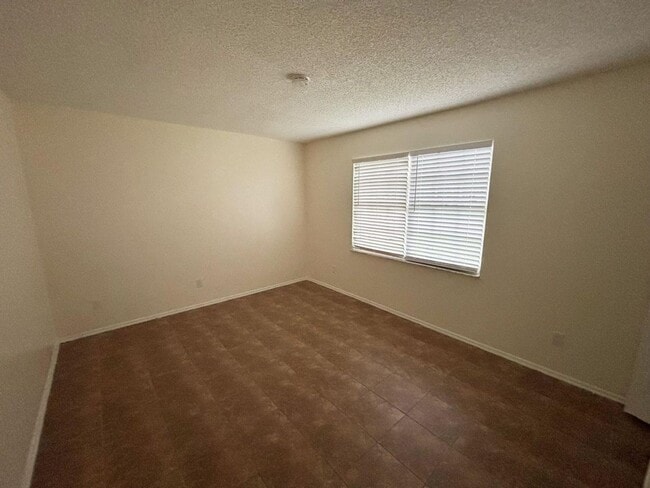 Building Photo - 2/2/1 home with a spacious fenced backyard...