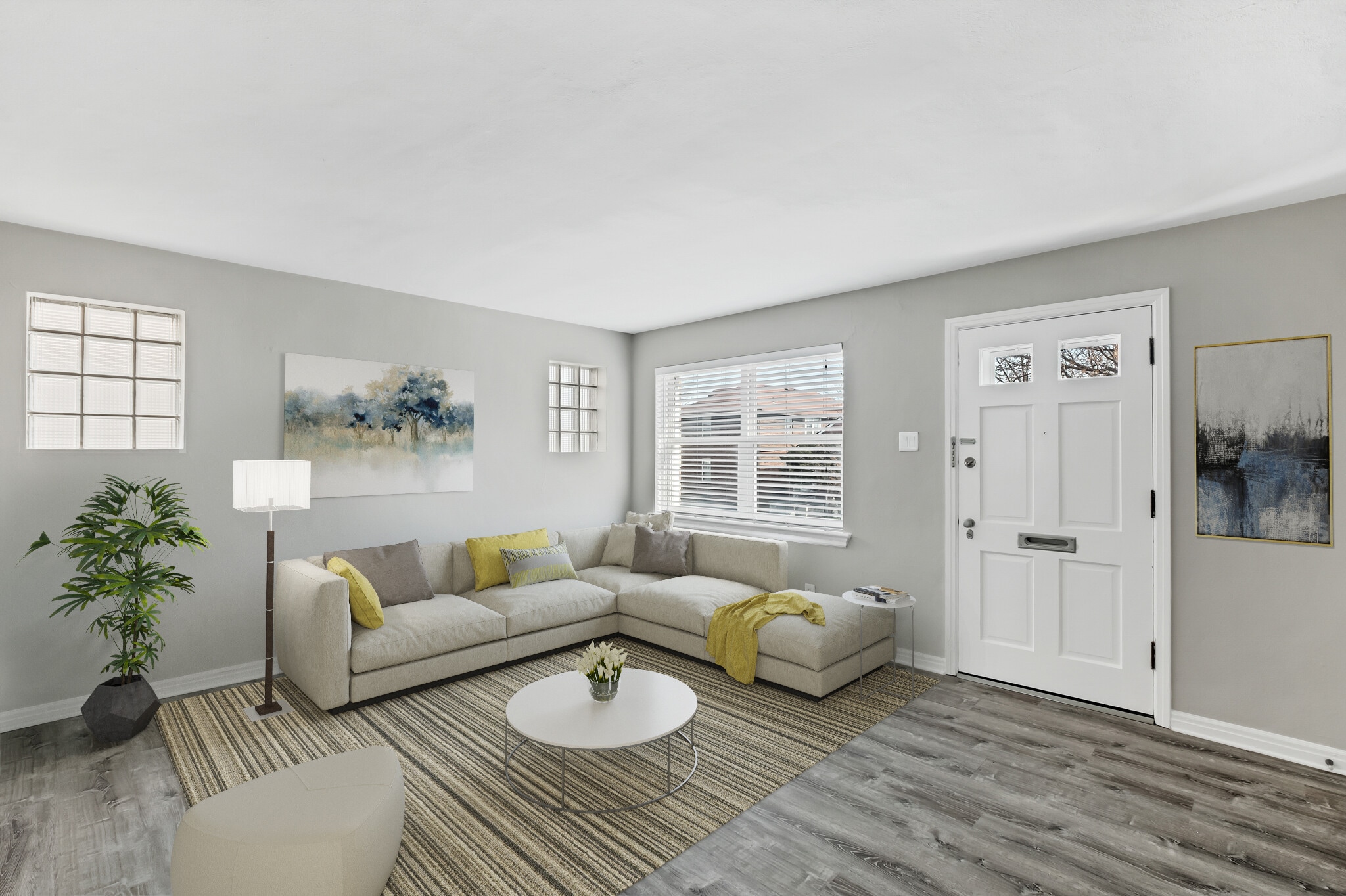 Virtually Staged living room showing arrangement with sectional. Opposite stair case wall allows for additional seating area, entry console, or set up a bar. - 3443 Lawn Ave