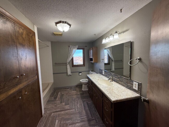 Building Photo - Spacious, four-bedroom, two-bathroom, coun...