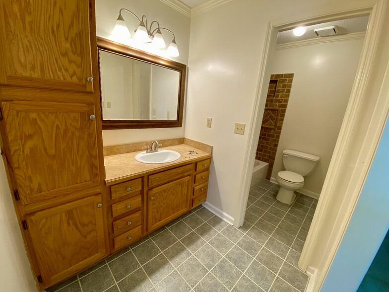 Each bath is tiled floors and generous storage options. - 7005 Sand Wedge Cir