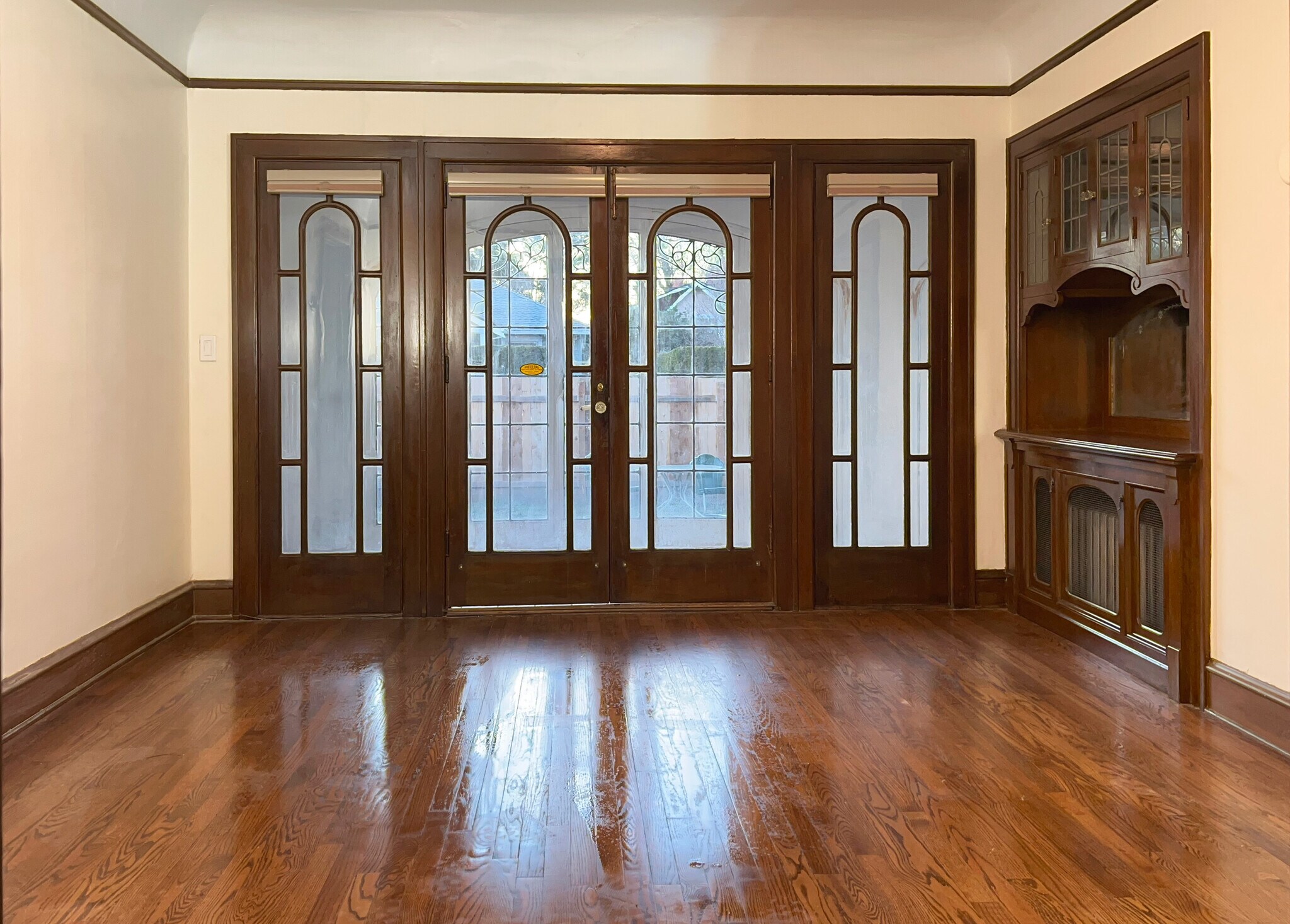 Dining room has a vintage built-in hutch and french doors that open to the sunroom. - 3448 SW Canby St