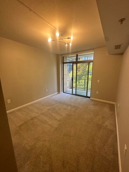 Secondary bedroom from entryway, secondary balcony in back. - 440 L St NW