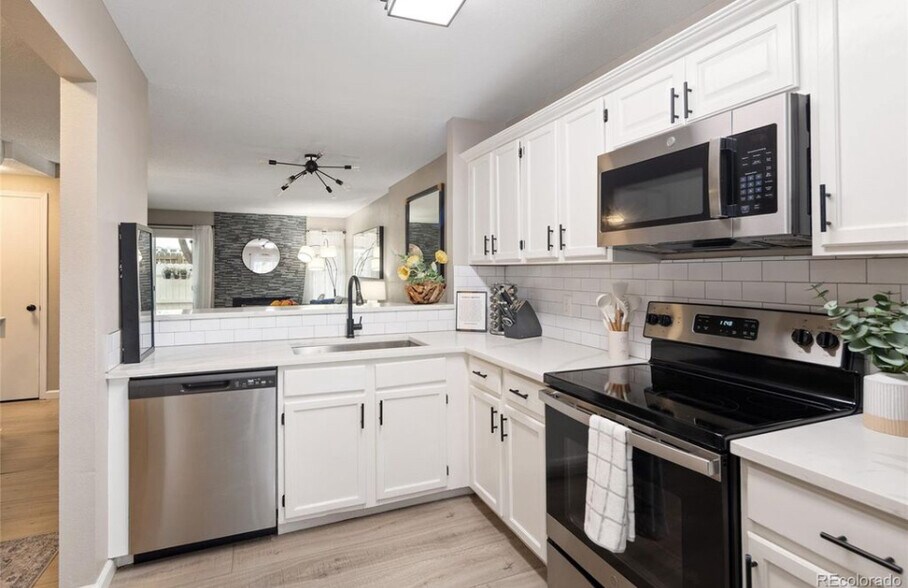Kitchen into living room - 10587 W Maplewood Dr