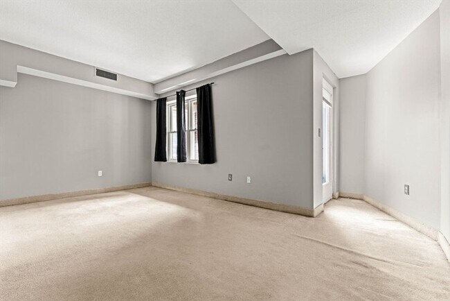 Building Photo - Updated 1BR Condo with Balcony, Garage Parking & Storage Near Commuter Rail