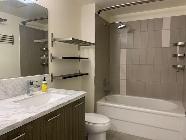 Building Photo - Modern 1BR Condo with Balcony, Concierge &...