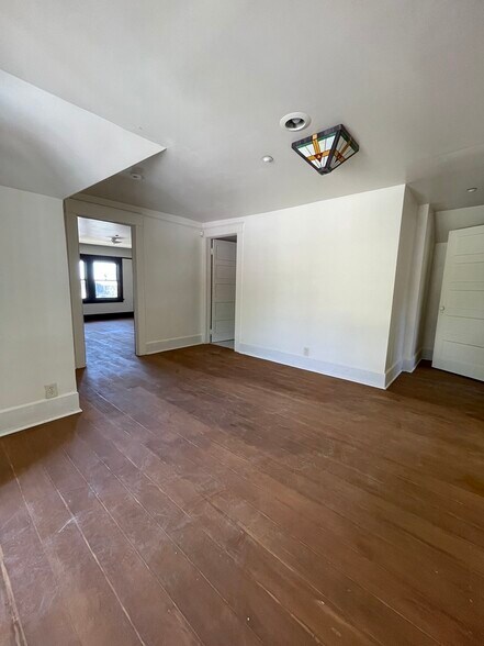 Large den area between two bedrooms and a separate porch with sitting area. - 1135 Magnolia St
