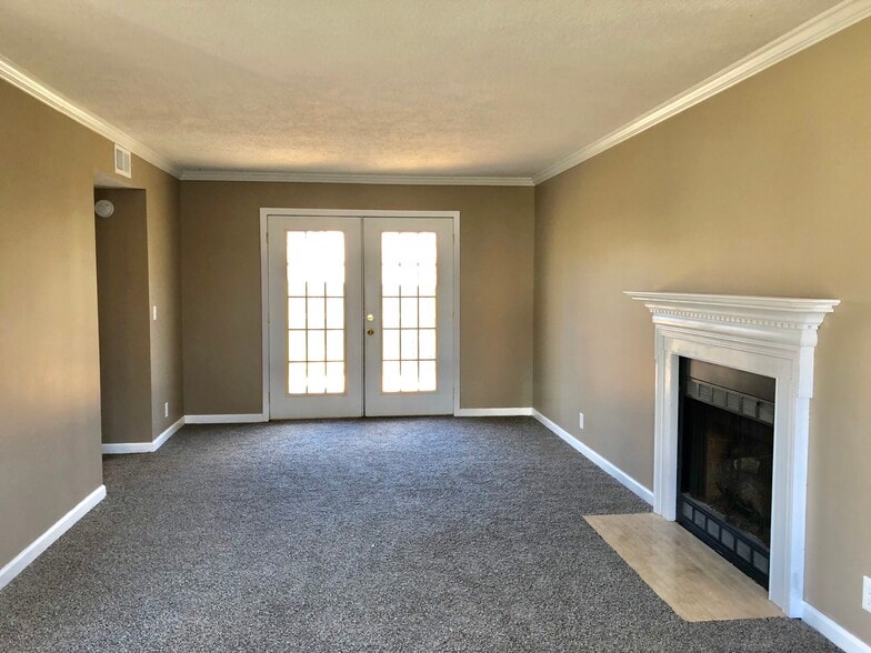 Living Room with gas fireplace and french door access to backyard - 346 N Birchwood Dr