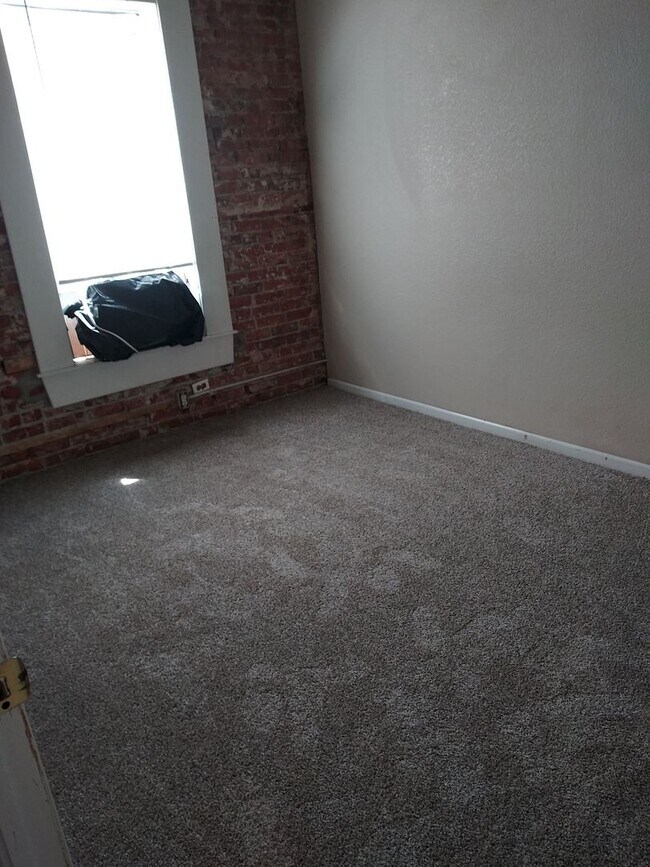 Building Photo - Large windows and exposed brick wall