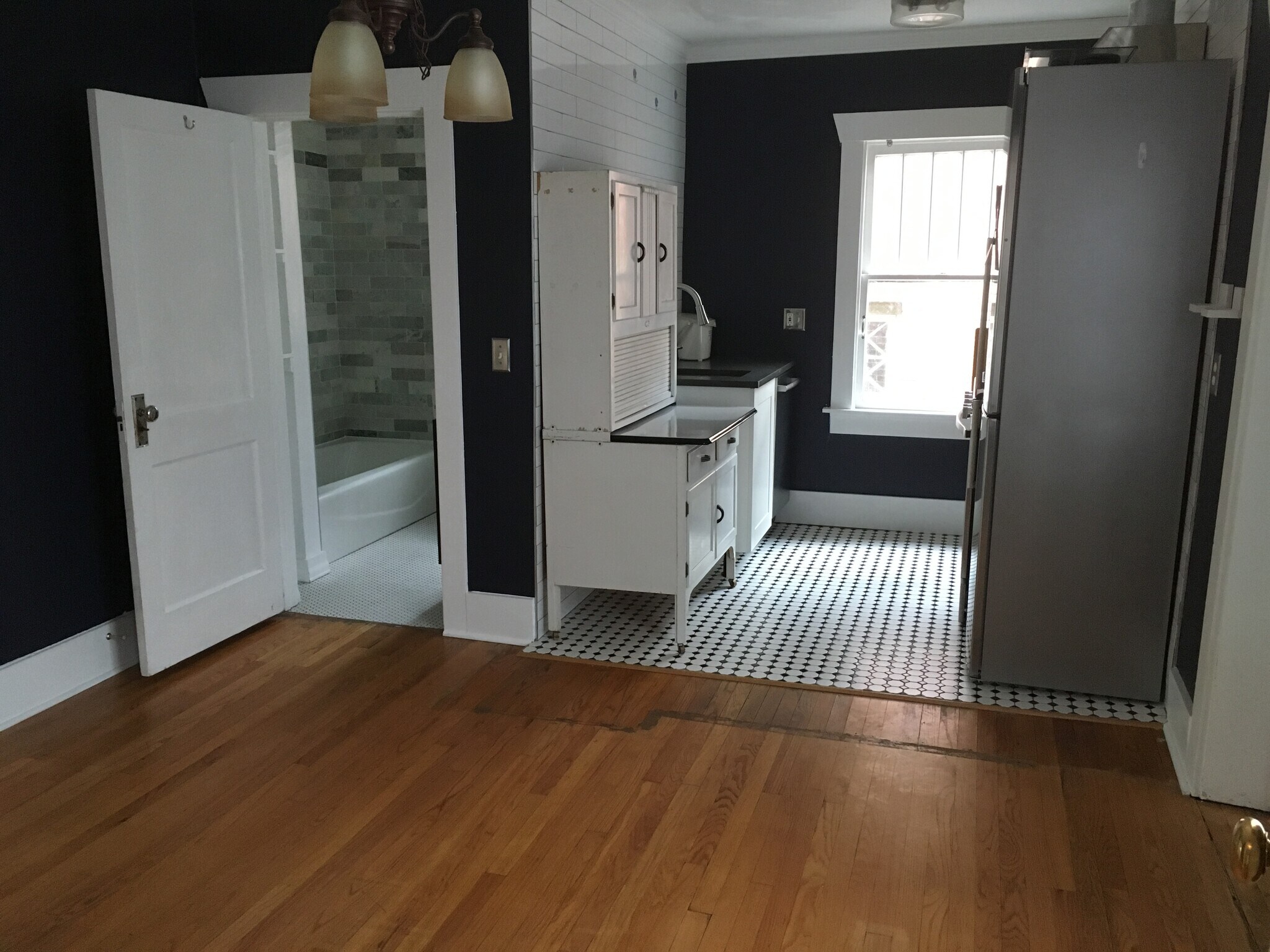 In the dining area looking into the kitchen and bathroom. - 945 Washington St