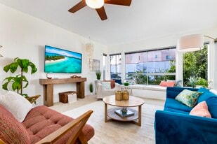 Bright open living area with ocean view, 65” 4K Smart TV, and designer furnishings - 2221 Ocean Ave