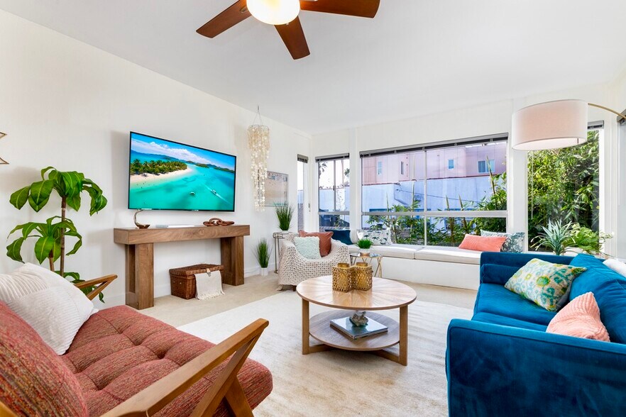 Bright open living area with ocean view, 65” 4K Smart TV, and designer furnishings - 2221 Ocean Ave