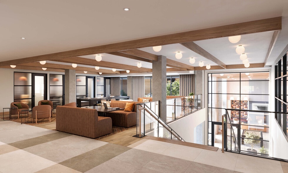 Modern loft-style apartment with elegant lighting, cozy seating, and panoramic windows overlooking a vibrant urban setting. - Bellamy Minnetonka