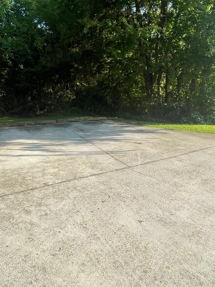 Concrete parking area - shared with downstair tenant - studio apartment. - 2415 Old North Hills St