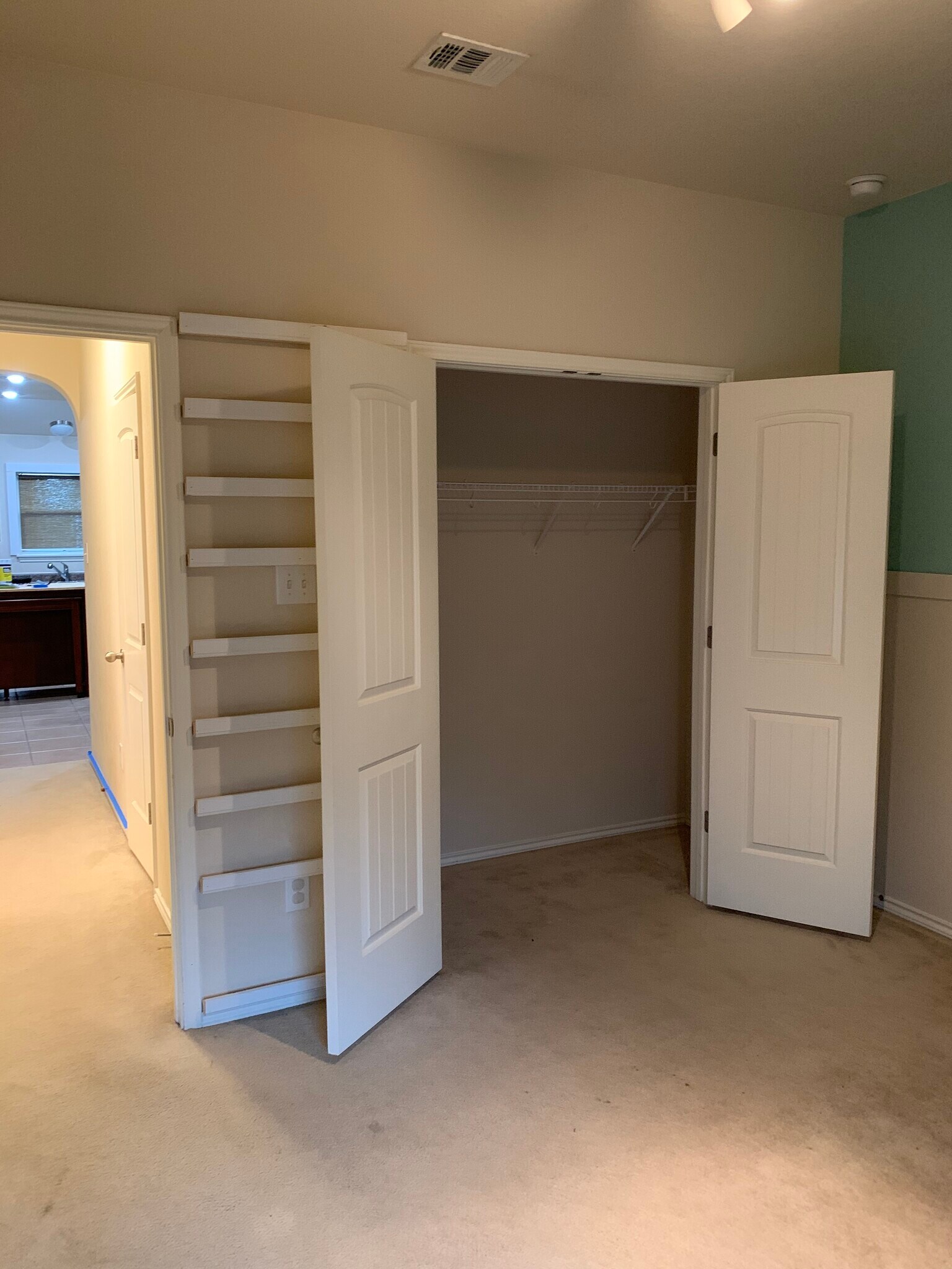Bedroom 3 with French door closet and built-in book display shelving - 15327 English River Loop
