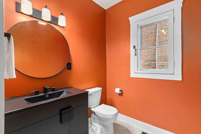 Brick & Black accents in the main half bath - 916 Hickory St